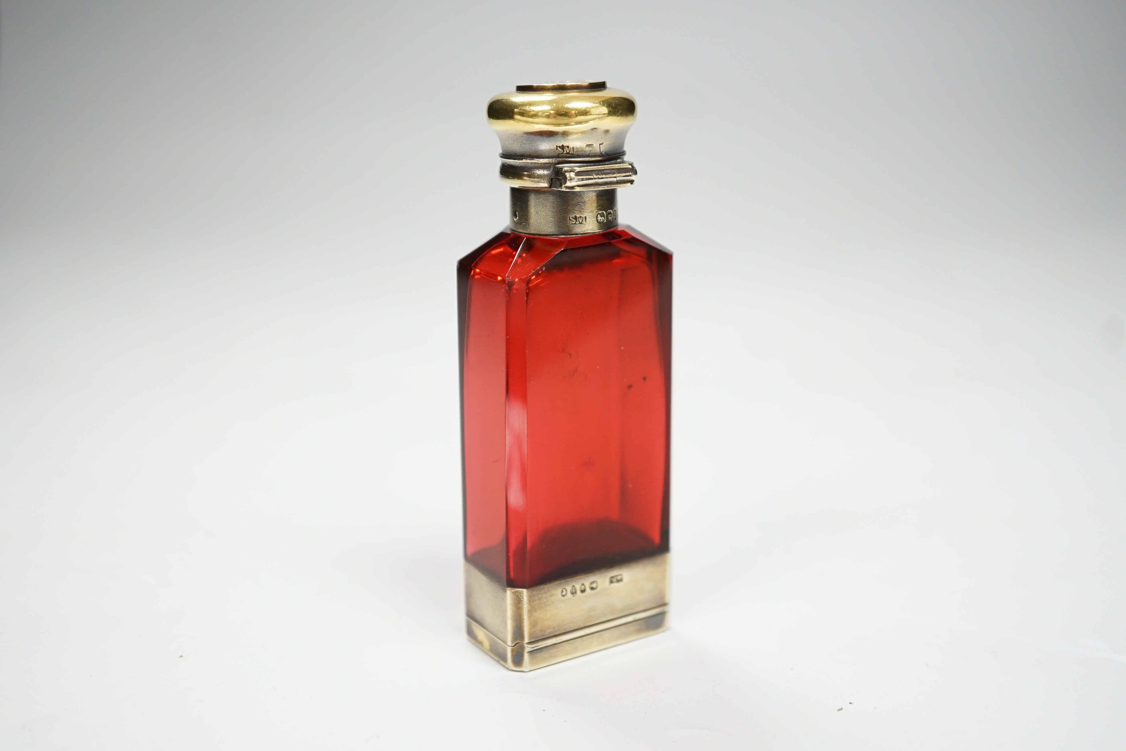 A late Victorian silver gilt mounted ruby glass combination scent bottle/vinaigrette, by Sampson Mordan & Co, London, 1877, 96mm.